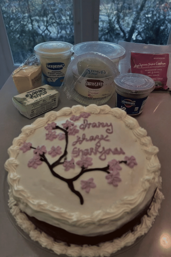 Sakura cake with cherry blossom branch piped on side