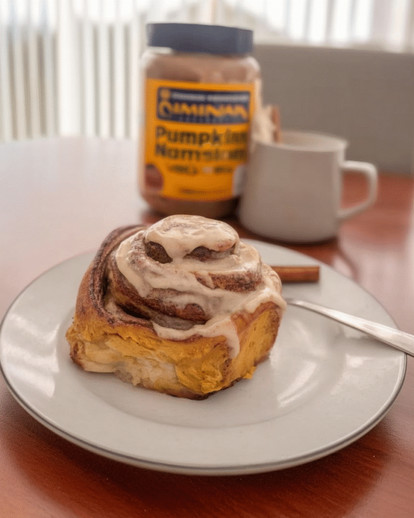 pumpkin cinnamon rolls served with coffee and fruit