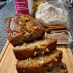 Zucchini bread loaf sliced on a wooden board