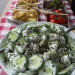 Creamy cucumber salad in a white bowl
