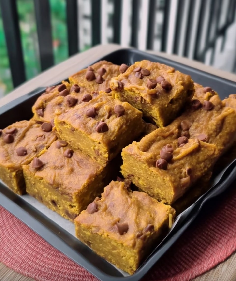 Chocolate chip pumpkin bars cut into squares on parchment