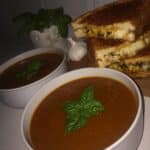 Comforting Roasted Tomato Basil Soup recipe! Roasting the tomatoes brings out a rich flavor. Get the full recipe and enjoy this soup with grilled cheese!