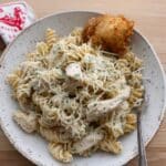 Easy Crockpot Garlic Parmesan Chicken Pasta recipe! Creamy, cheesy, and delicious, this simple slow cooker dinner with chicken, rotini, and Buffalo Wild Wings Parmesan Garlic sauce is a family favorite. Get the recipe!
