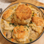 Chicken pot pie filling topped with biscuit for cozy fall dinner recipes