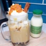 Iced Pumpkin Cream Chai Tea Latte in clear glass with foam