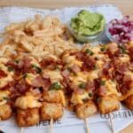 Loaded Tater Tot Skewers: Cheesy tater tot appetizers with bacon and ranch seasoning, perfect for game day or parties! Get the easy recipe for these delicious and fun tailgate food skewers.