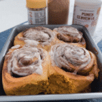 pumpkin cinnamon rolls easy in a baking pan with golden tops