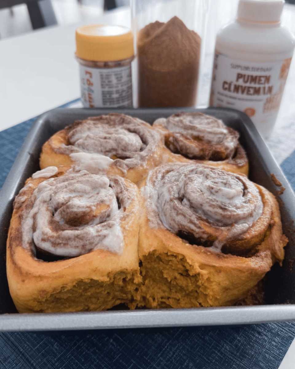 pumpkin cinnamon rolls easy in a baking pan with golden tops