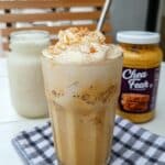 Starbucks Iced Chai with Pumpkin Cream Cold Foam recipe. Make this delicious tea latte at home with chai tea concentrate, milk, heavy cream, and pumpkin puree. Top with nutmeg for a perfect fall treat. #pumpkincreamcoldfoam #chaitea #starbucksrecipe