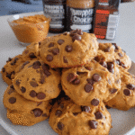 Soft pumpkin cookies on a cooling rack with chocolate chips