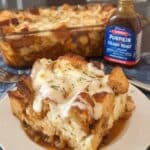 Pumpkin french toast casserole in white baking dish with golden streusel