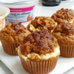Freshly baked pumpkin muffins with golden tops on cooling rack