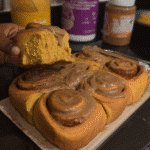 Pumpkin spice cinnamon rolls with creamy chai glaze on plate