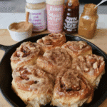 Sourdough pumpkin cinnamon rolls on a rustic wooden table
