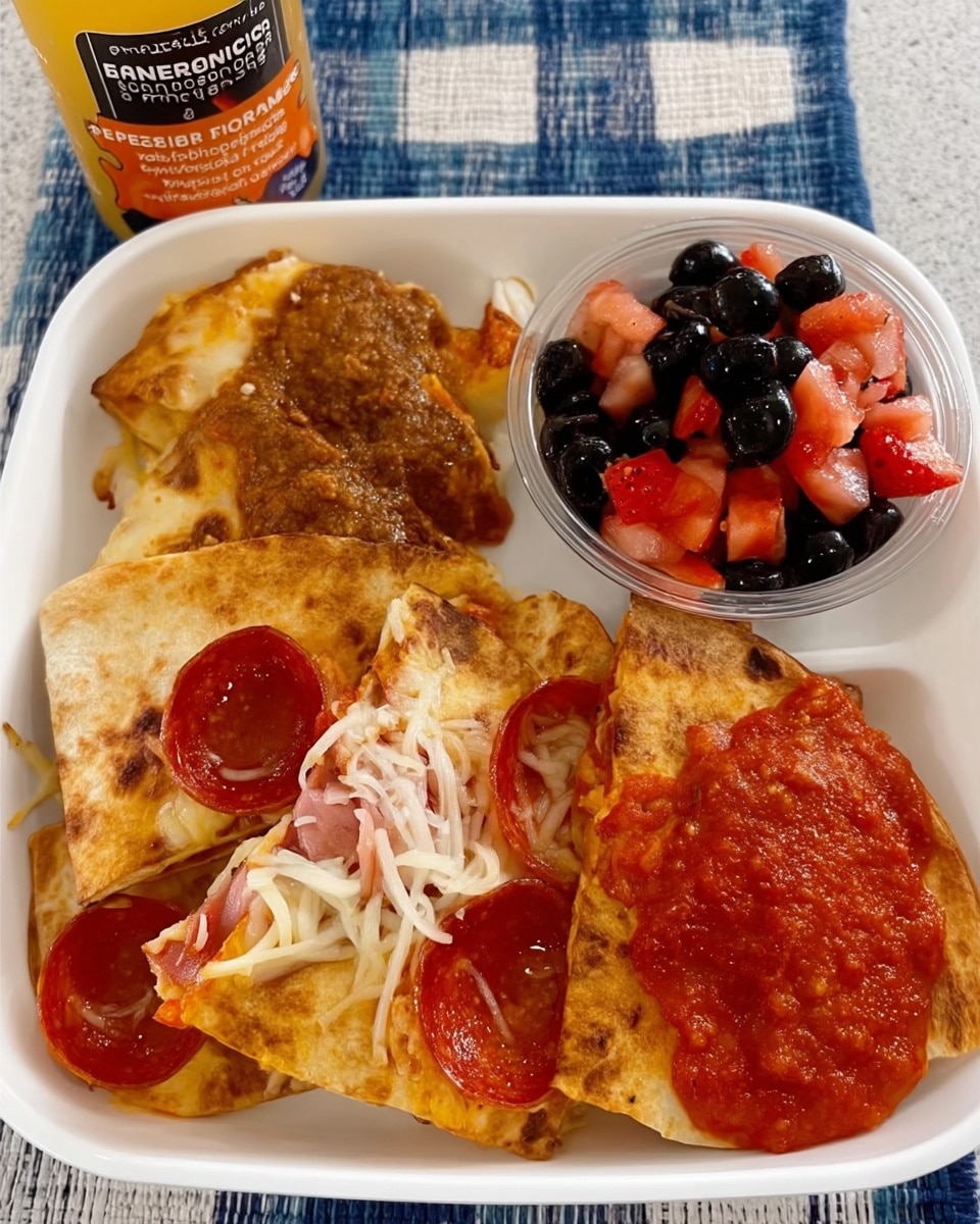 Quick Pepperoni Pizza Quesadilla recipe! The perfect easy lunch idea for kids and adults. Great for picky eaters, school lunches, daycare meals, or a fun and simple weeknight dinner. Get the recipe and tips for packing in lunchboxes.
