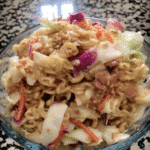 A bowl of colorful Asian Slaw with chopsticks.