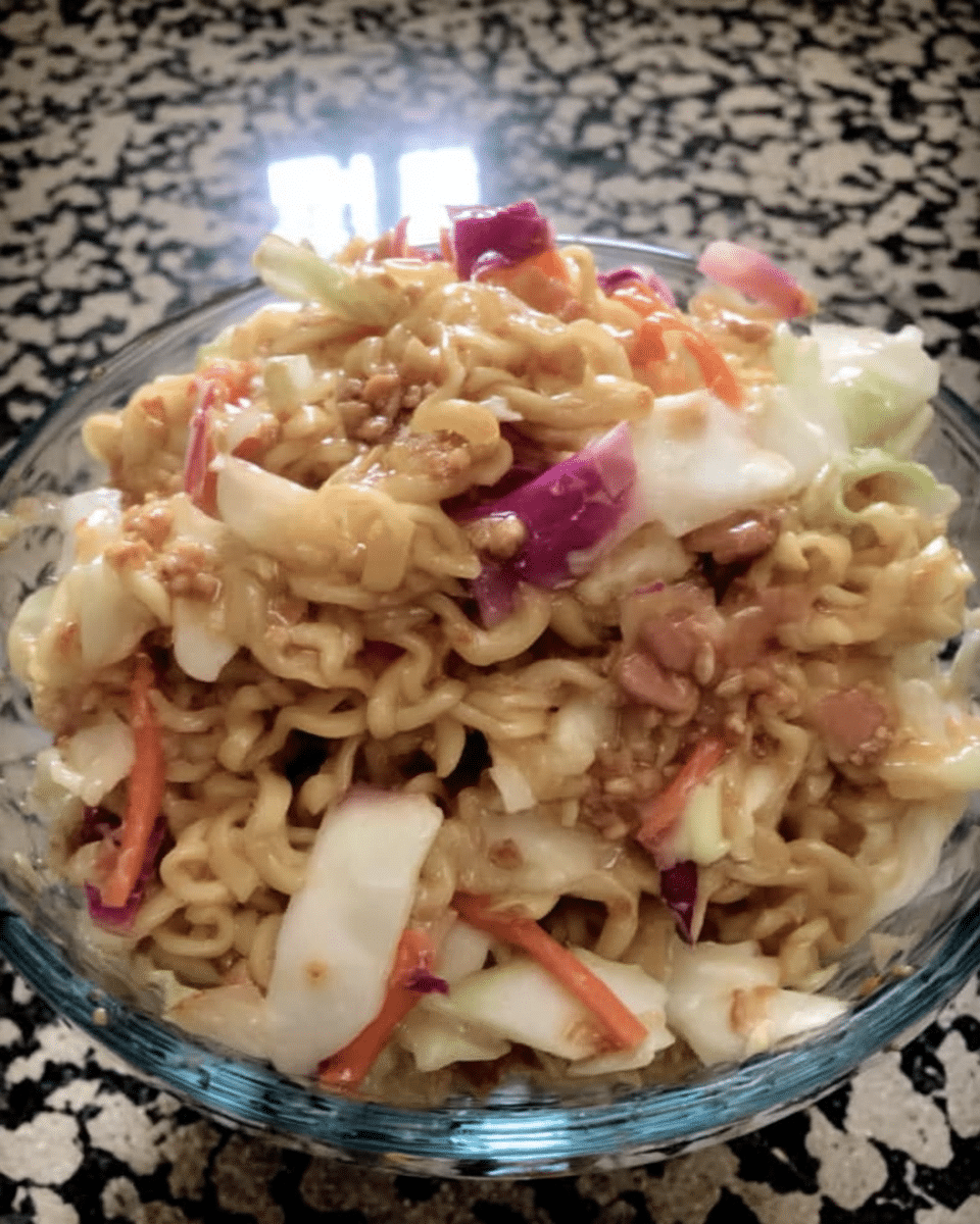 A bowl of colorful Asian Slaw with chopsticks.