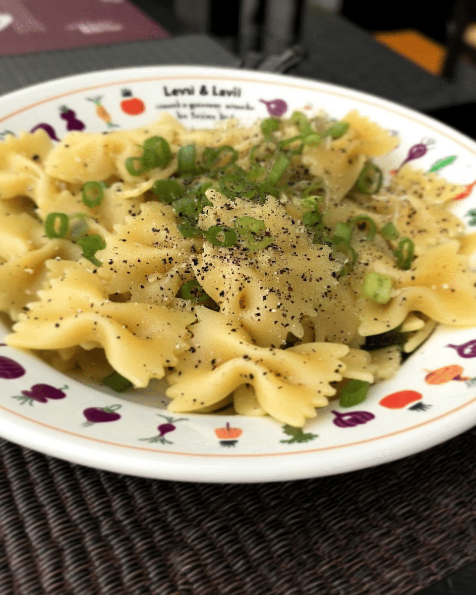 A close-up of Creamy Corn Pasta with Basil being stirred in a pan