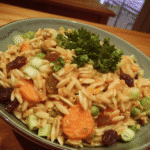 A colorful Harvest Orzo Salad in a wooden bowl.