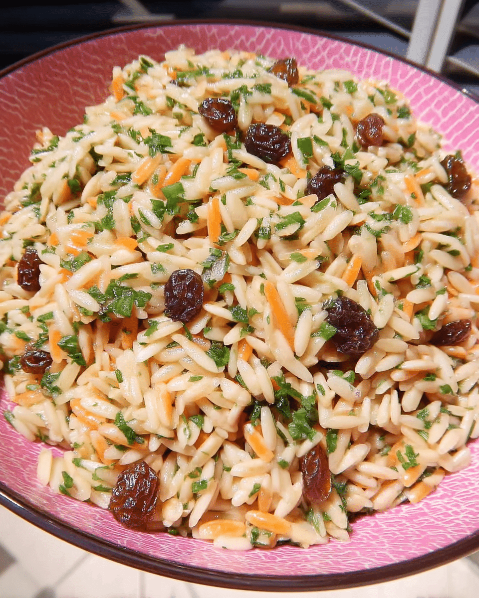 Harvest Orzo Salad served on a plate with a side of grilled chicken.