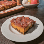 Ingredients for pumpkin coffee cake arranged on a wooden table.