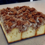 A slice of moist and delicious pumpkin coffee cake with a thick streusel topping.