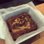 Close-up of a slice of pumpkin fudge brownie, showing the swirled layers of fudgy brownie and pumpkin.