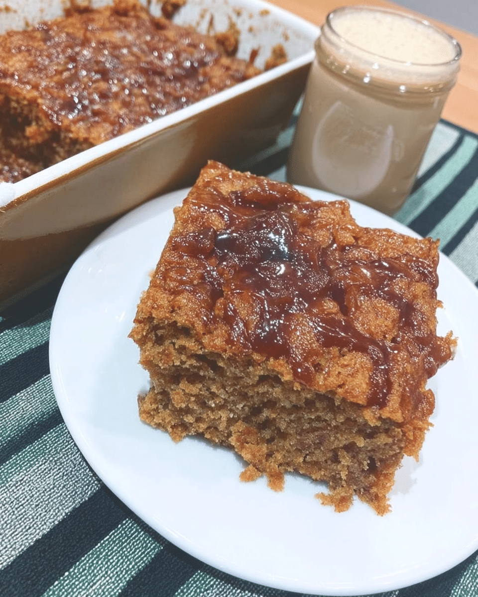 A slice of pumpkin coffee cake on a plate with a fork.