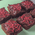 Spiderweb Brownies on a Halloween-themed plate