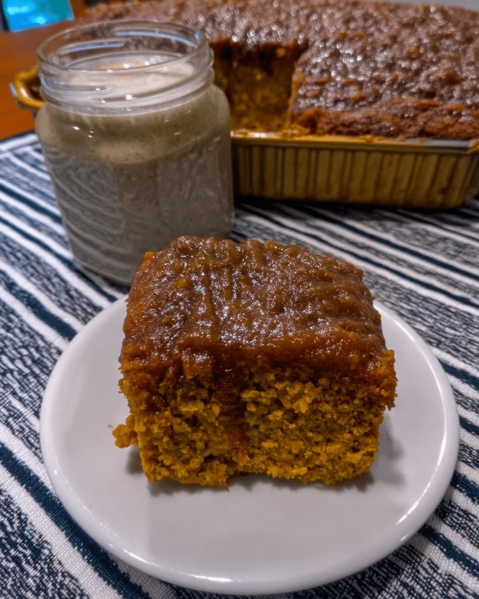 A close-up shot of the streusel topping being spread over the pumpkin coffee cake batter.