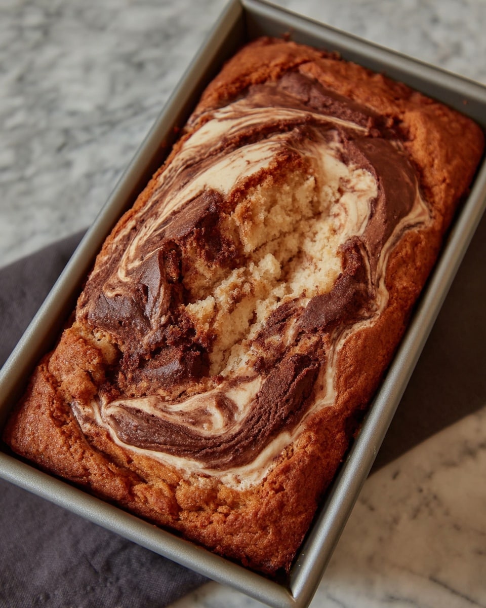 Swirled pumpkin bread with cream cheese on parchment