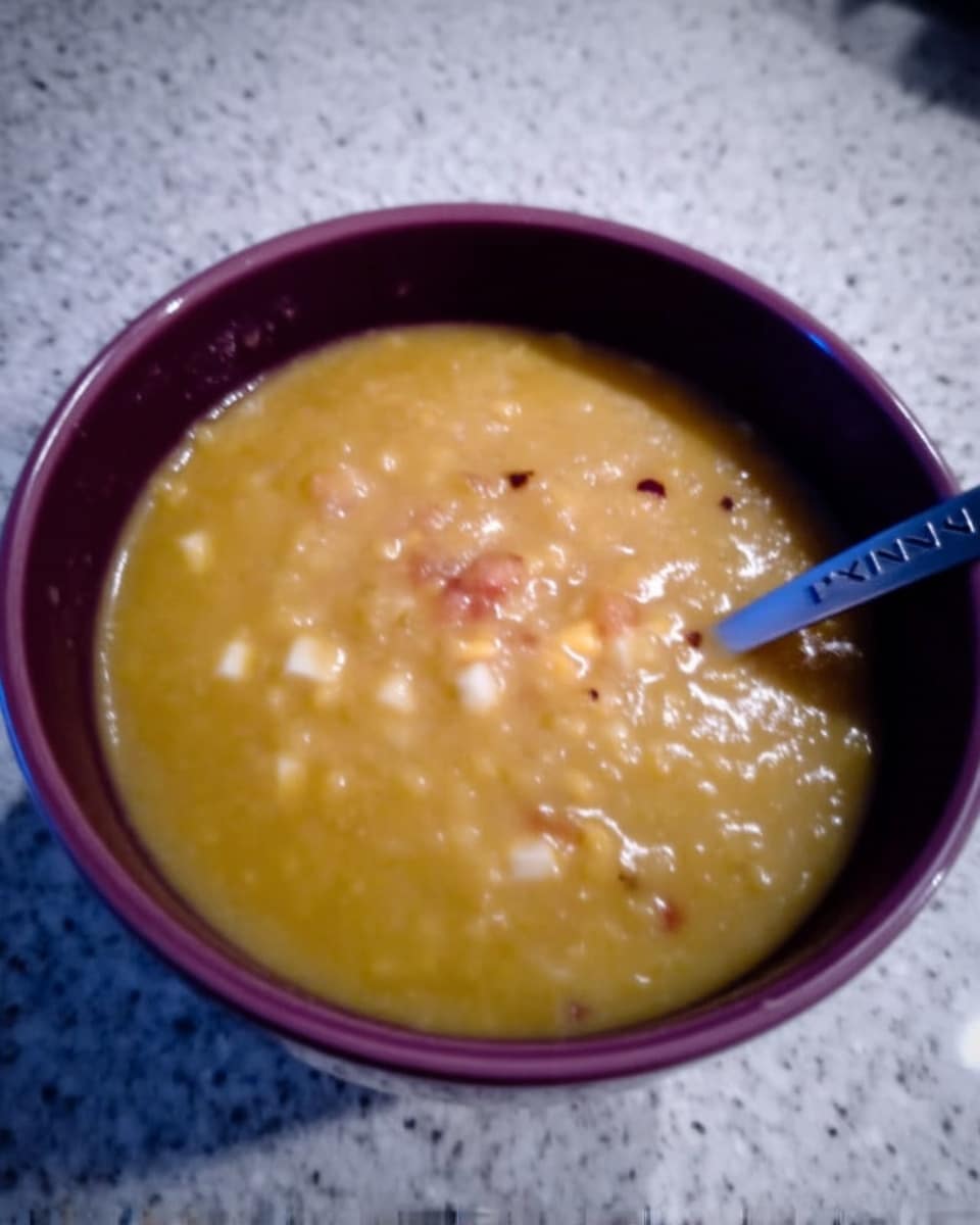 Bowl of pumpkin soup with drizzle of pumpkin spice syrup